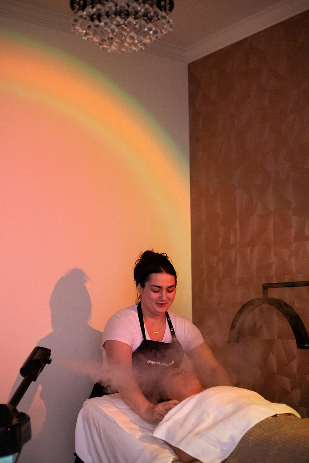 Sarah Comerford Licensed esthetician performing a relaxing facial treatment at The Infinity Glow in Placentia, CA